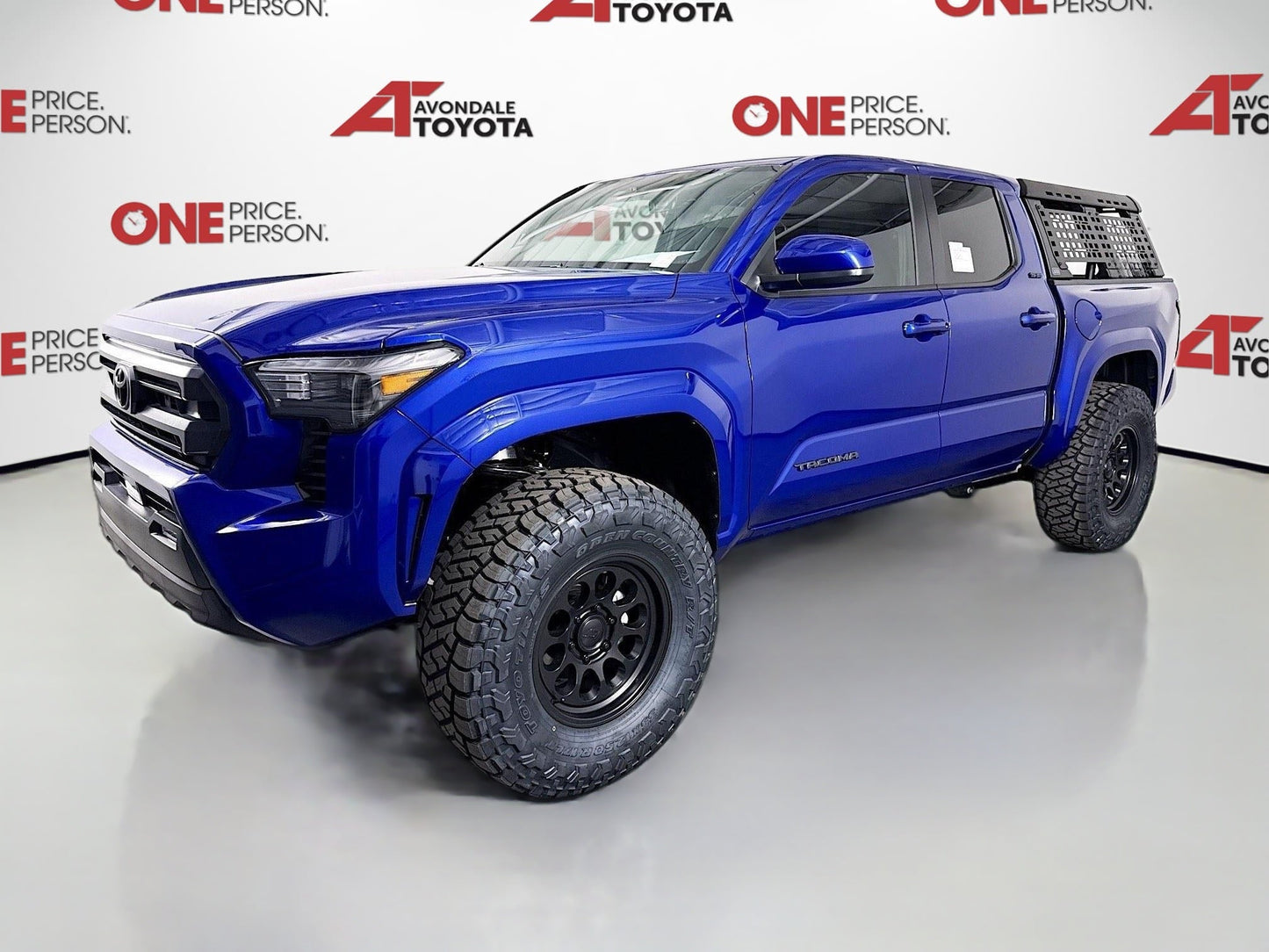Blue 2025 Toyota Tacoma with 2.5-inch Ready Lift and off-road tires installed by dealership