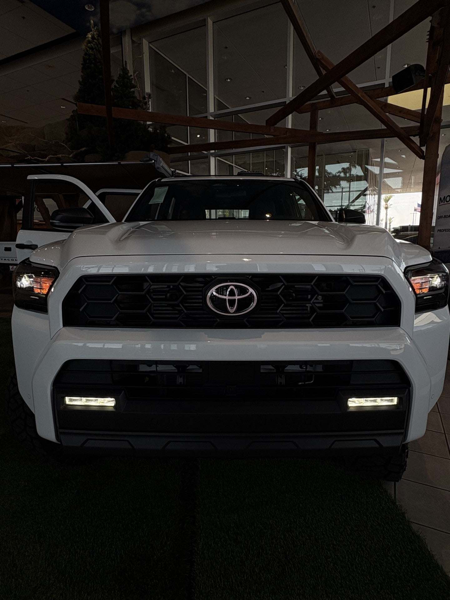 White Toyota truck in a showroom setting