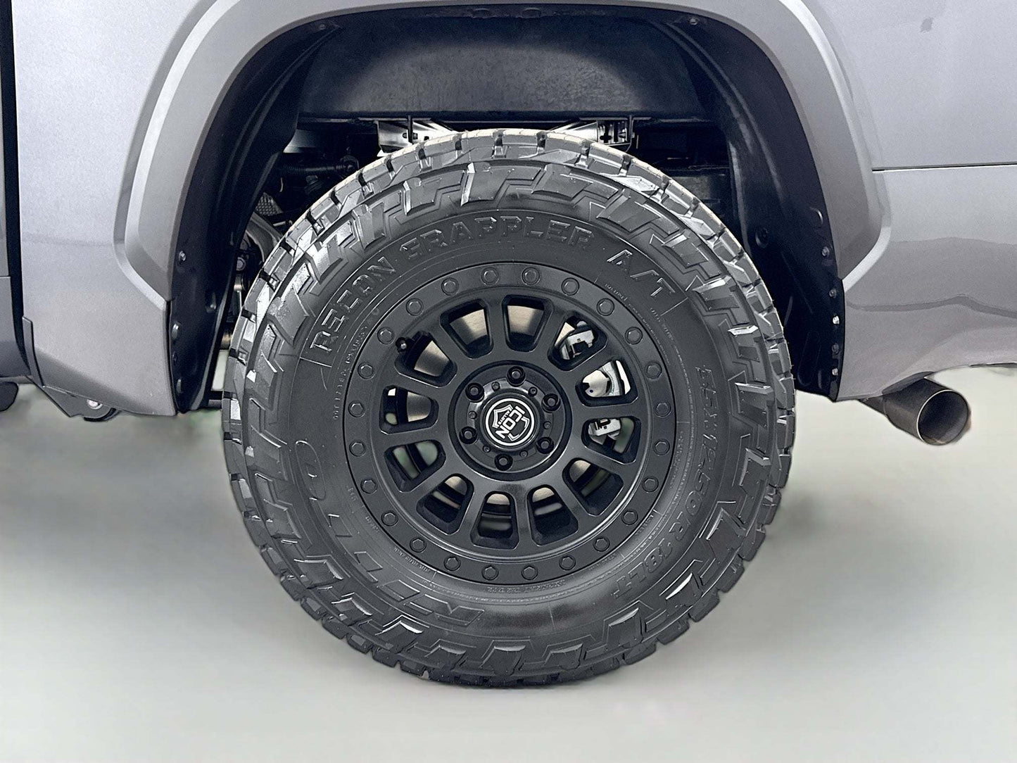 Close-up of a tire on a vehicle with a white background