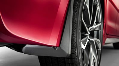 Close-up of Toyota Corolla mudguards protecting rear wheel area on red car