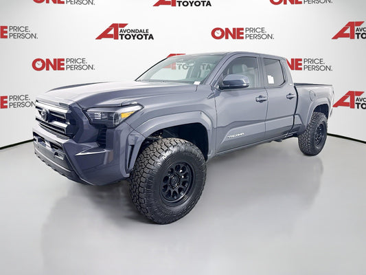 2025 Tacoma with 1.5-inch front level lift package and upgraded off-road tires in a showroom.