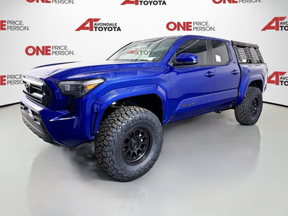 Blue 2025 Toyota Tacoma with 2.5-inch Ready Lift and off-road tires installed by dealership