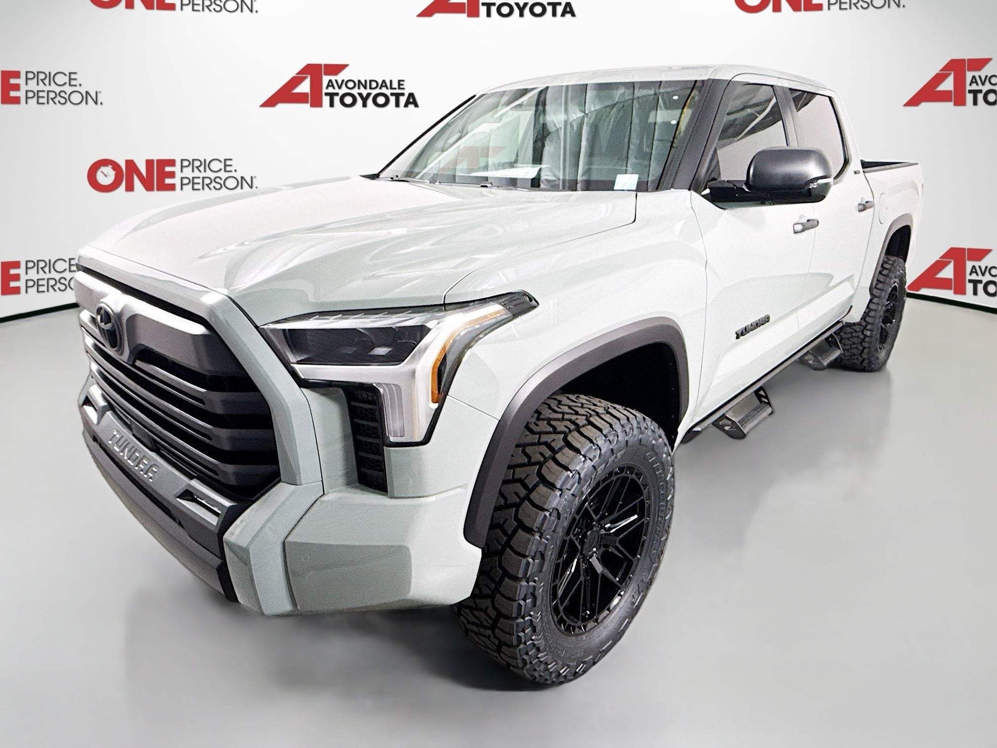 White 2025 Tundra with 3.5-inch lift, black off-road wheels, and rugged tires in showroom