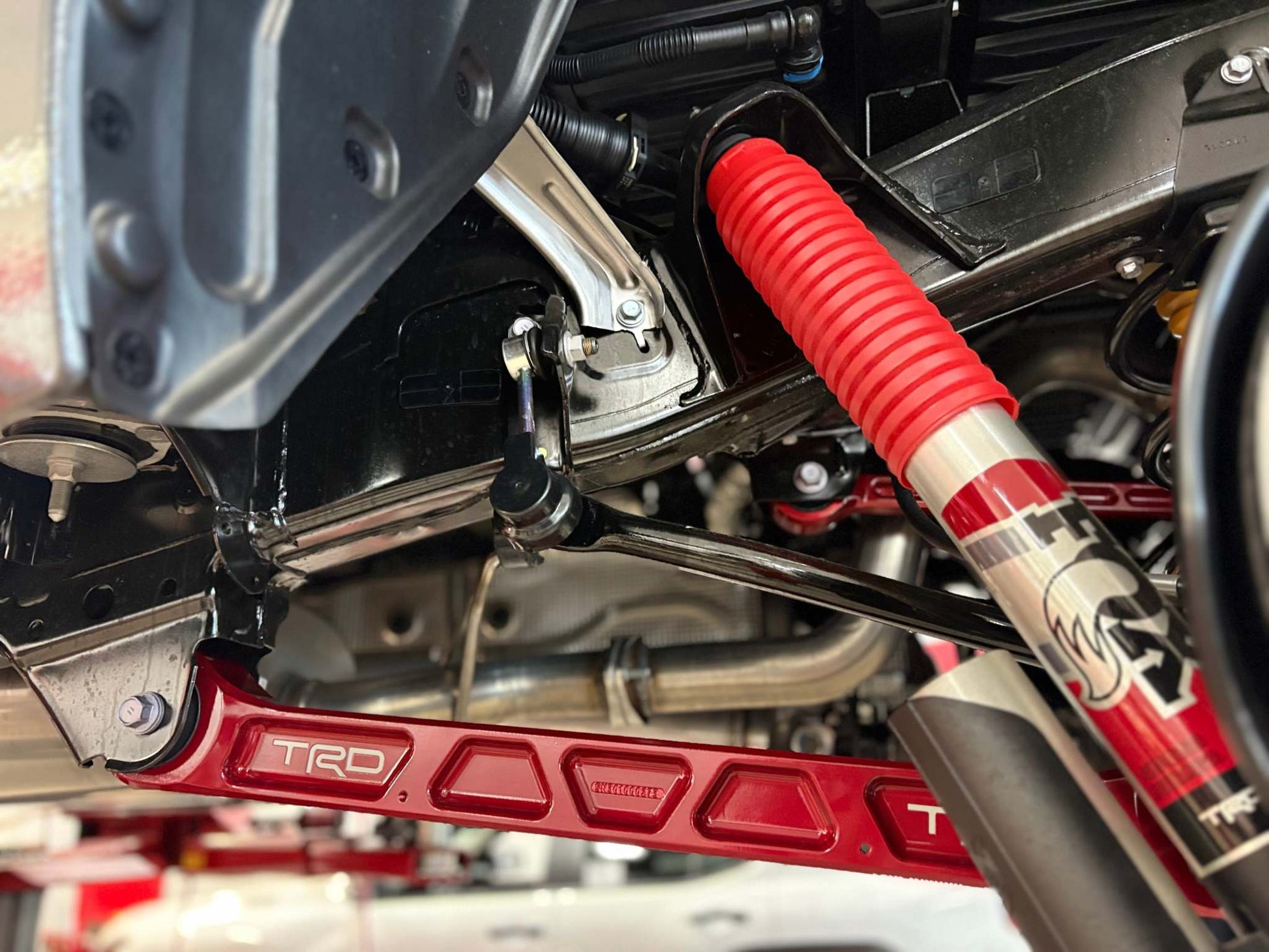 Tundra Billet Rear Trailing Arms forged aluminum with TRD red anodized finish and height control brackets for 2022-2026 Tundra suspension upgrade