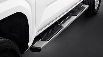 2025 Tacoma side steps installed on white truck for easier access and enhanced style